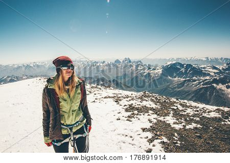 Woman climber reached Elbrus mountain summit Travel Lifestyle success concept adventure active vacations outdoor happy emotions enjoying peaks range landscape