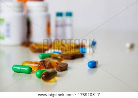 Background of assorted pharmaceutical capsules and medication in different colors.