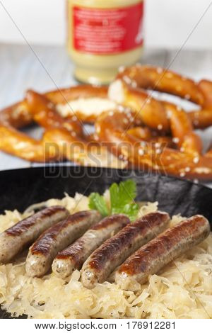 nuremberg bratwurst on cabbage in a pan