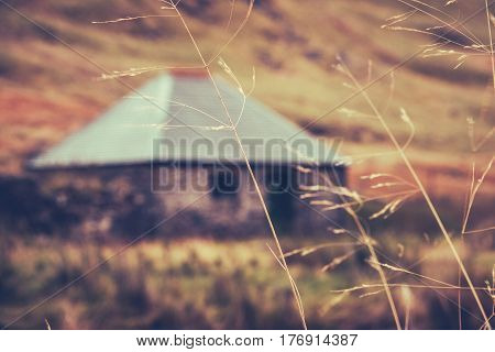 A Scottish Bothy or Hut Or Cottage In The Winter With Grass In The Foreground