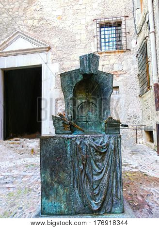 Pals, Girona, Spain - September 15, 2015: The bronze monument of the sculptor Josep Maria Subirachs, dedicated to the builders of the Cathedral of GironaOld town of Pals in Girona, Catalonia at Spain.