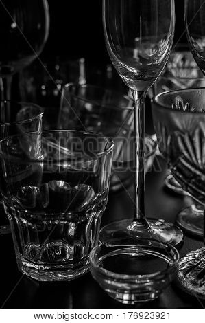 Clean different glasses on dark background. vertical