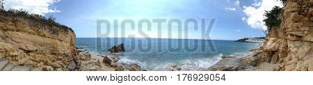 Panoramic of Cupecoy in St. Martin/St. Maarten showing the interesting geological rock formations with Caribbean sea and interesting sky.