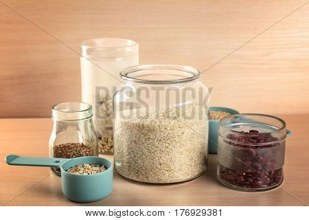 Kitchen containers with groceries on wooden table