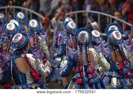 ORURO, BOLIVIA - FEBRUARY 25, 2017: Caporales dancers in ornate costumes performing as they parade through the mining city of Oruro on the Altiplano of Bolivia during the annual carnival.