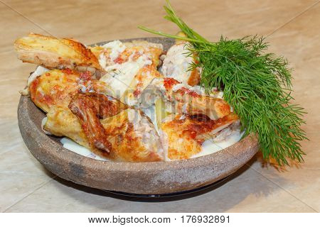 Tasty food. Roast chicken carcass with greenery on a Clay dishes