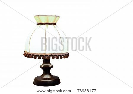 Old wooden desk lamp isolated on a white background with a light bulb turned on