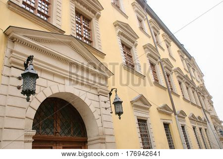 Facade of an ancient building with arch wood door.horizontal