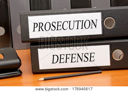 Prosecution and Defense - two binders on desk in the office
