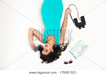 beautiful young girl with red lips smiling on a white background with trvael accessories