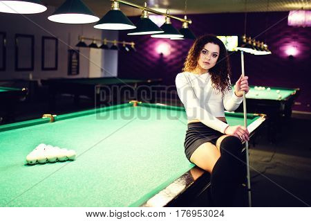 Young Curly Girl Posed Near Billiard Table. Sexy Model At Black Mini Mini Skirt Play Russian Snooker