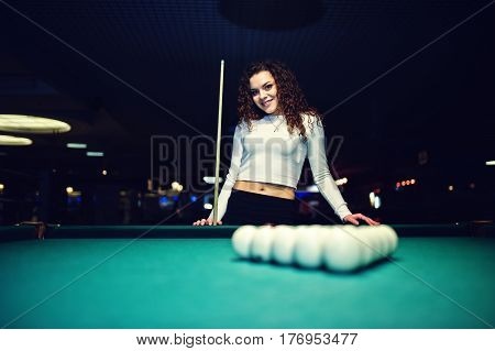 Young Curly Girl Posed Near Billiard Table. Sexy Model At Black Mini Mini Skirt Play Russian Snooker