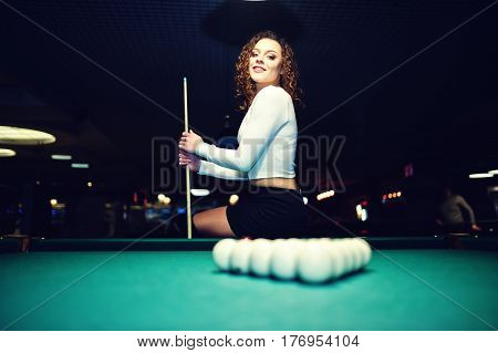 Young Curly Girl Posed Near Billiard Table. Sexy Model At Black Mini Mini Skirt Play Russian Snooker