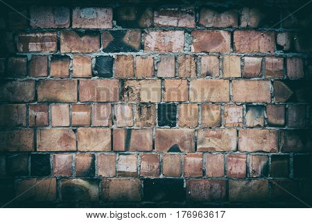Fragment of old brick wall with multicolored bricks and tones background