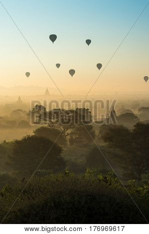 Hot air balloons fly over ancient pagodas in Bagan Mandalay region Myanmar (Burmar). Most popular destination in southeast asia.