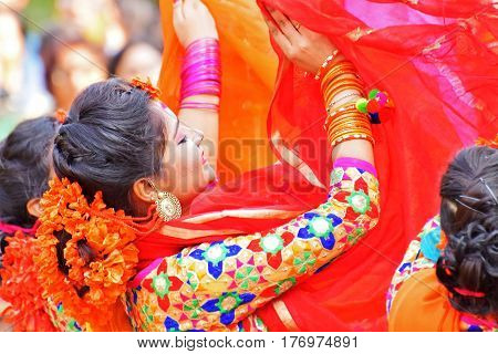 KOLKATA INDIA - MARCH 12 2017: Young girl dancers joyful dance at Holi/Spring festivalknown as Dol (in Bengali) or Holi (in Hindi) celebrating arrival of Spring in India. Popular Indian festival.
