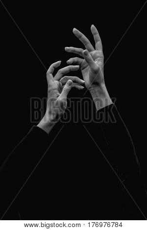 Cutel ballerinas hands on a black background