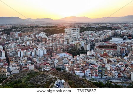 Beautiful view of the old town and Mount Benacantil from Santa Barbara Castle. Enjoying the sunset. Alicante, Spain