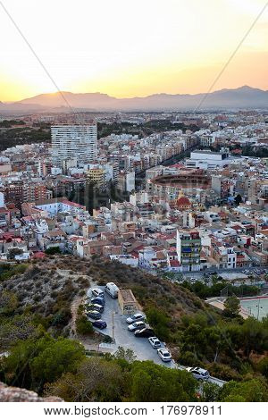 Beautiful view of the old town and Mount Benacantil from Santa Barbara Castle. Enjoying the sunset. Alicante, Spain