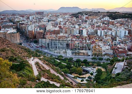 Beautiful view of the old town and Mount Benacantil from Santa Barbara Castle. Enjoying the sunset. Alicante, Spain
