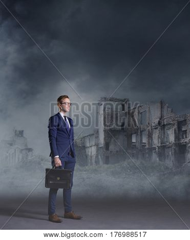 Businessman standing on apocalyptic background. Crisis, default, setback concept.