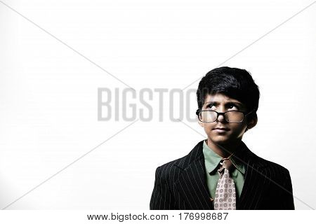 Cute Intelligent Little Boy Wearing Glasses On Nose isolated on white background