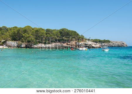 Crystalline Light Blue Sea And Speed Boats Of One Little Cove Of Minorca Island