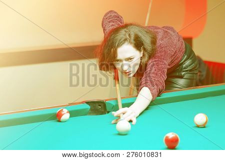 Young Brunette Girl Playing Snooker. Young Happy Woman Having Fun With Billiard. Smiling Fashionable