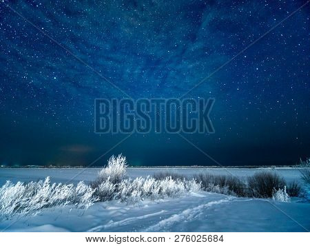 Snow At Field And Starry Winter Sky. Snowy Moonless Winter Night At Northen Of Europe.