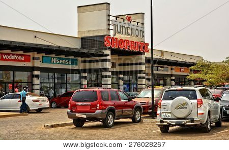 Shopping Center And Cars. Vehicles In A Parking Lot. Shopping Mall. World Brands: Shoprite, Hisense,