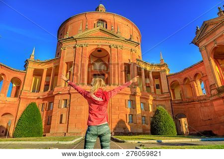 Carefree Woman With Open At Arms At Madonna Of San Luca Sanctuary. Popular Tourist Destination In Bo