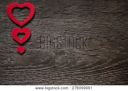 Three Red Hearts Are Located On An Old Wooden Brown Dry Board, One Less Than The Other. Valentines D