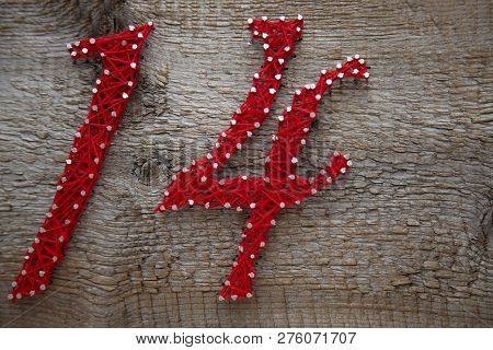 Number 14 In Red Threads On An Old Dry Board