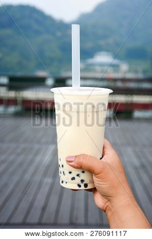 Glass Of Milk Bubble Tea With Tapioca Pearls In Tourist Hand With Sun Moon Lake Background, Milk Bub