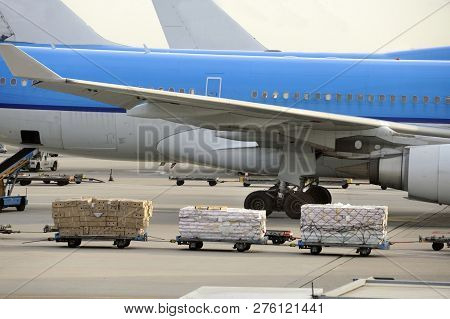 Airfreight At An Airport With Parked Airplanes