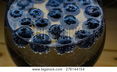 Blueberries In Soft Drinks With Bubbles Closeup