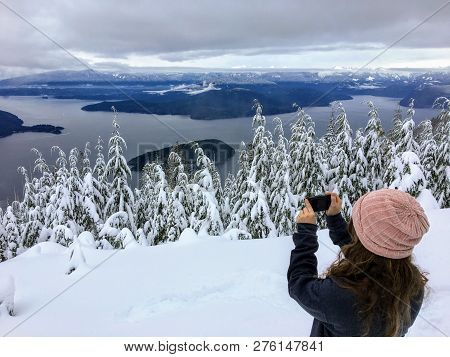 A Taking A Picture Atop Cypress Mountain Overlooking The Ocean Blow. In The Distance Hikers And Snow