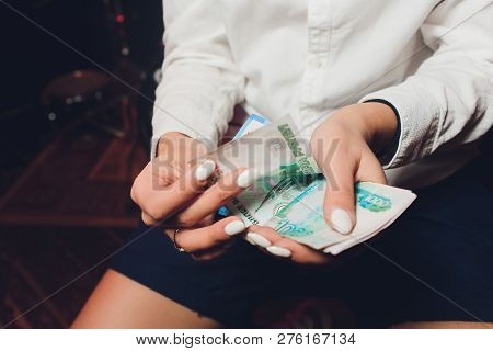 Russian Rubles In The Hand Of A Fan.male Hand Holding Many Of The Russian Banknotes.the Transfer Of 