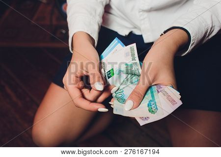 Russian Rubles In The Hand Of A Fan.male Hand Holding Many Of The Russian Banknotes.the Transfer Of 