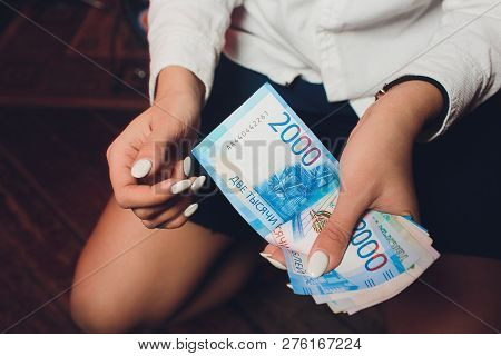 Russian Rubles In The Hand Of A Fan.male Hand Holding Many Of The Russian Banknotes.the Transfer Of 