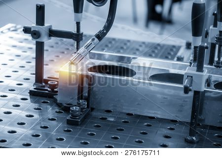 The Welding Robot Machine For Welding Automotive Part In The Light Blue Scene.industrial 4.0 Concept