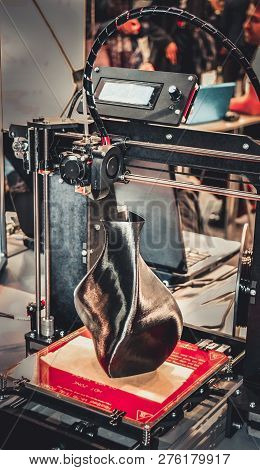 3d Printer Printing A Model In The Form Of Black Vase Close-up.