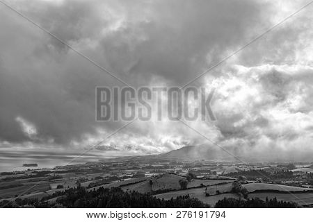 Black And White Shot Of Clouds Billowing Above The Town Of Vila Franca Do Campo In Sao Miguel, Azore