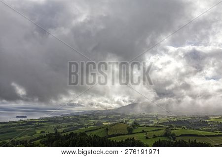 Rain Falls In The Distance On Pasture And Farm Land Above Vila Franca Do Campo In Sao Miguel, Azores