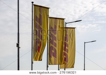 Sofia, Bulgaria - 17 October, 2018: Three Yellow Dhl Flags Are Seen Waving With The Wind Outside Of 