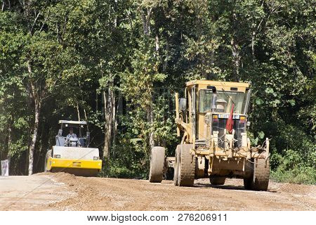 Asian Thai Workers Use Heavy Machinery Motor Grade And Vibratory Roller Working Made And Build Road