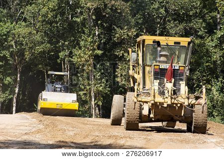 Asian Thai Workers Use Heavy Machinery Motor Grade And Vibratory Roller Working Made And Build Road