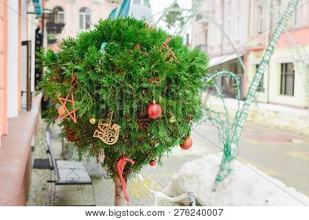 Tuya In The Shape Of A Ball Is Decorated As A New Year Link With Red Balls And Tree Toys On The Stre