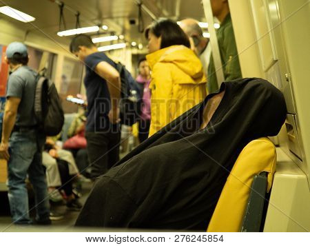 San Francisco, Ca October 6, 2018: Man Sleeps With Shirt Over His Head On A Crowded Bart Subway Car