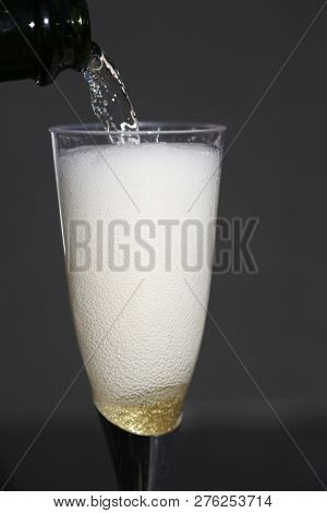 Champagne. Pouring Champagne into a glass. Glass of Champagne.